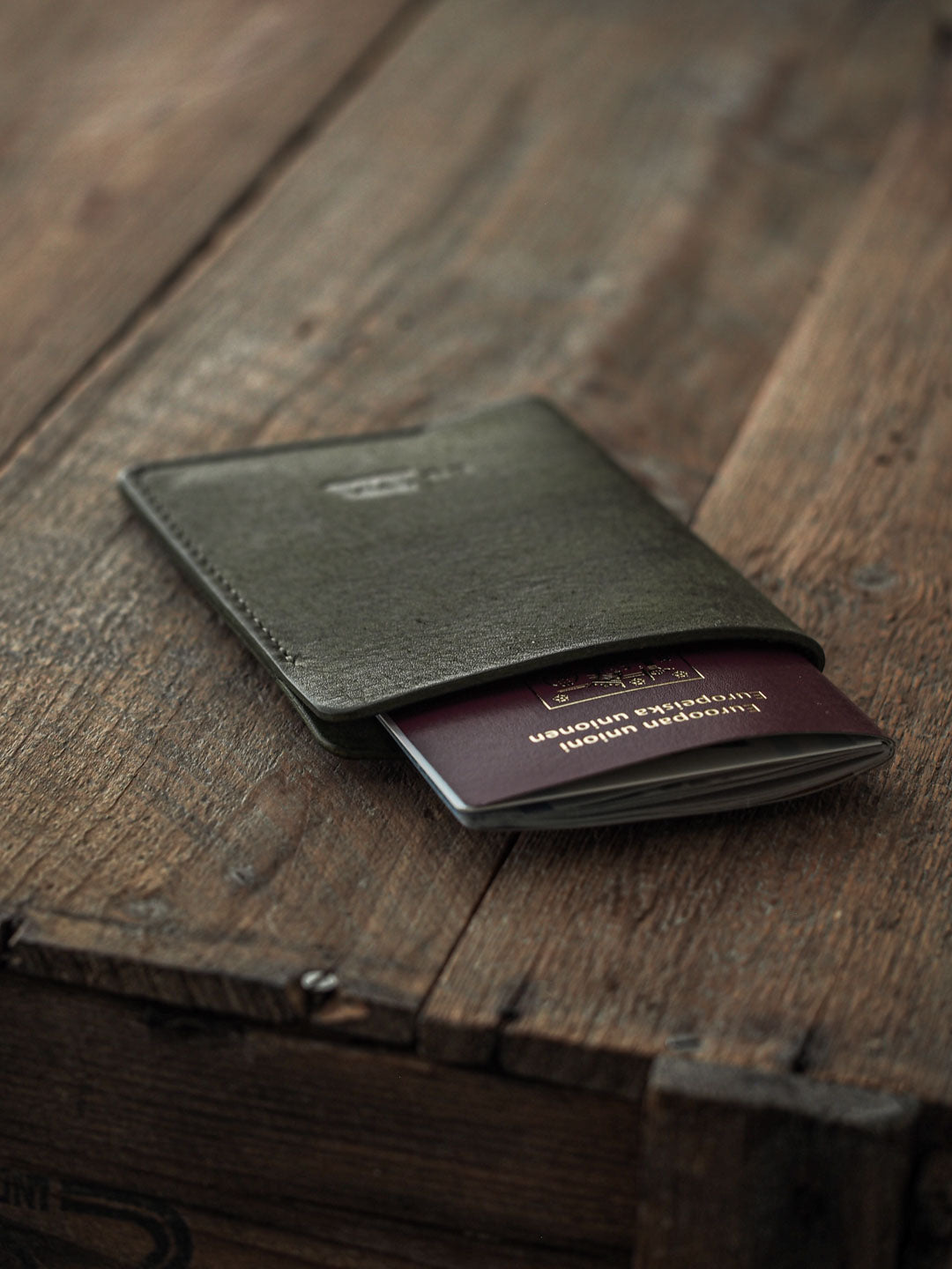 Luava handmade leather passport cover. color pine. front in use