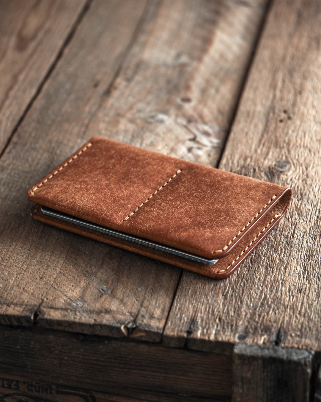 Luava handmade leather passport wallet cognac closed in use angle