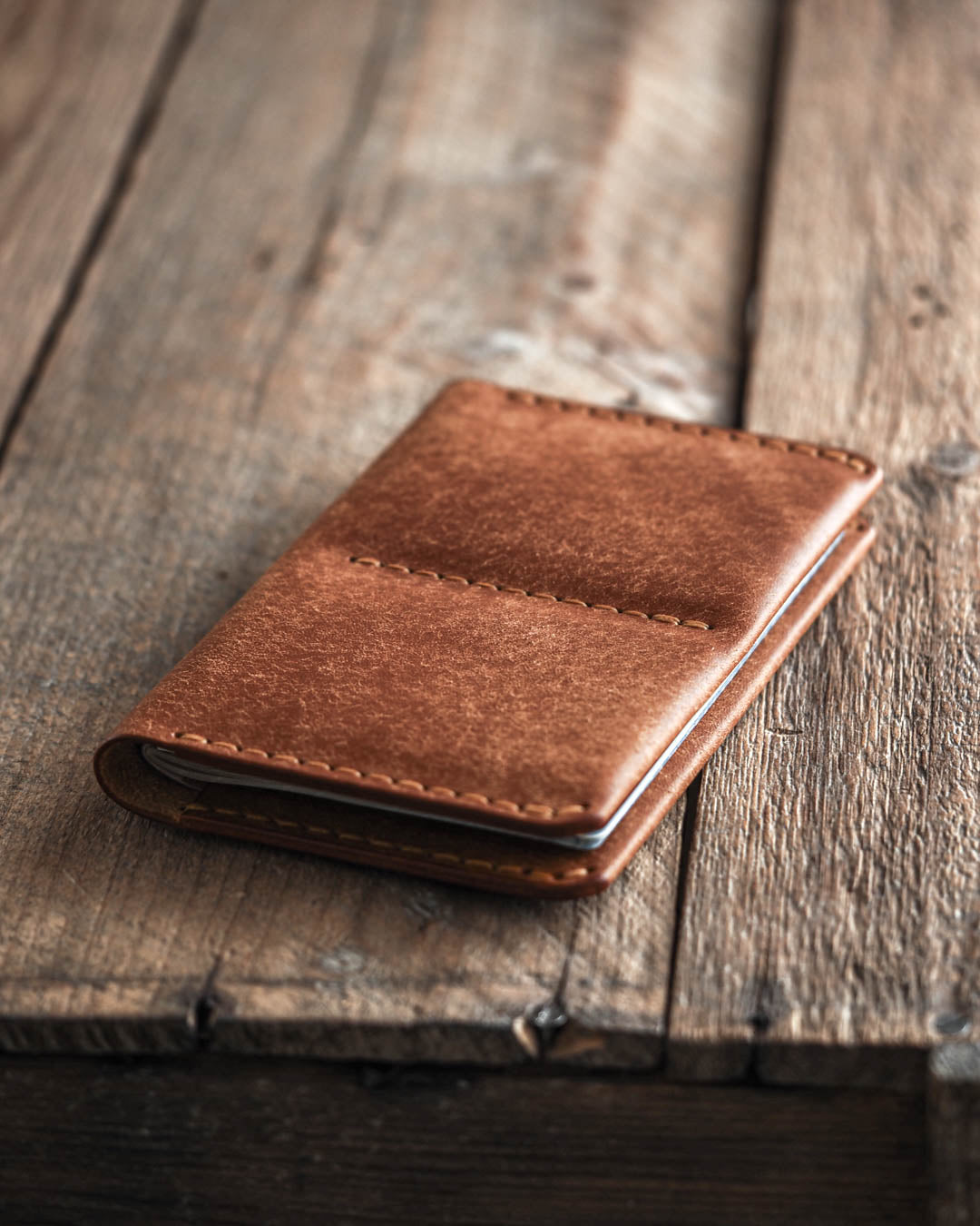 Luava handmade leather passport wallet cognac front in use