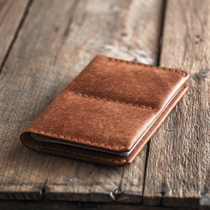 Luava handmade leather passport wallet cognac front in use