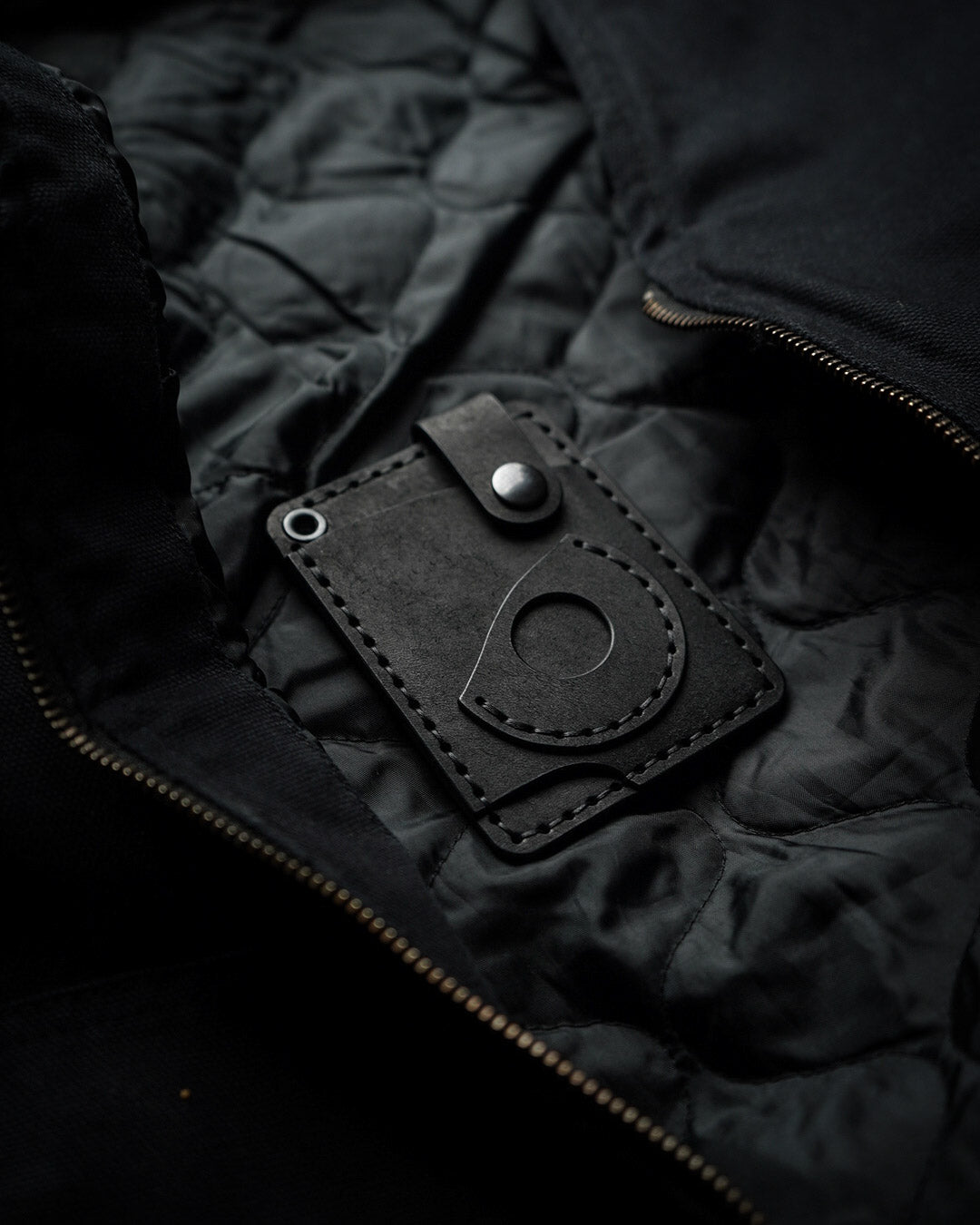 Luava x EDC.CULT edc wallet in black. handmade with full-grain vegetable-tanned leather. Everyday carry wallet with airtag pocket. angle