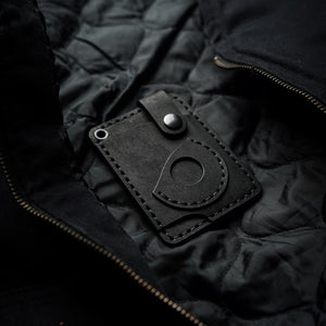 Luava x EDC.CULT edc wallet in black. handmade with full-grain vegetable-tanned leather. Everyday carry wallet with airtag pocket. angle