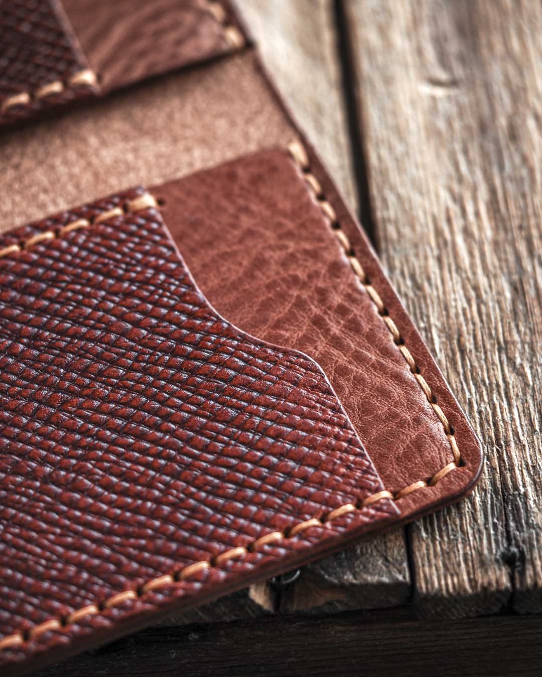 Close-up of a brown leather wallet on a wooden surface