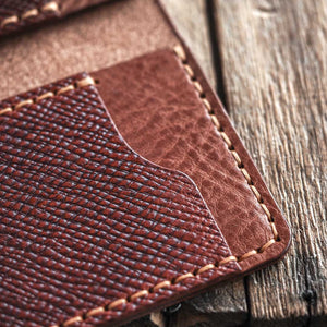 Close-up of a brown leather wallet on a wooden surface