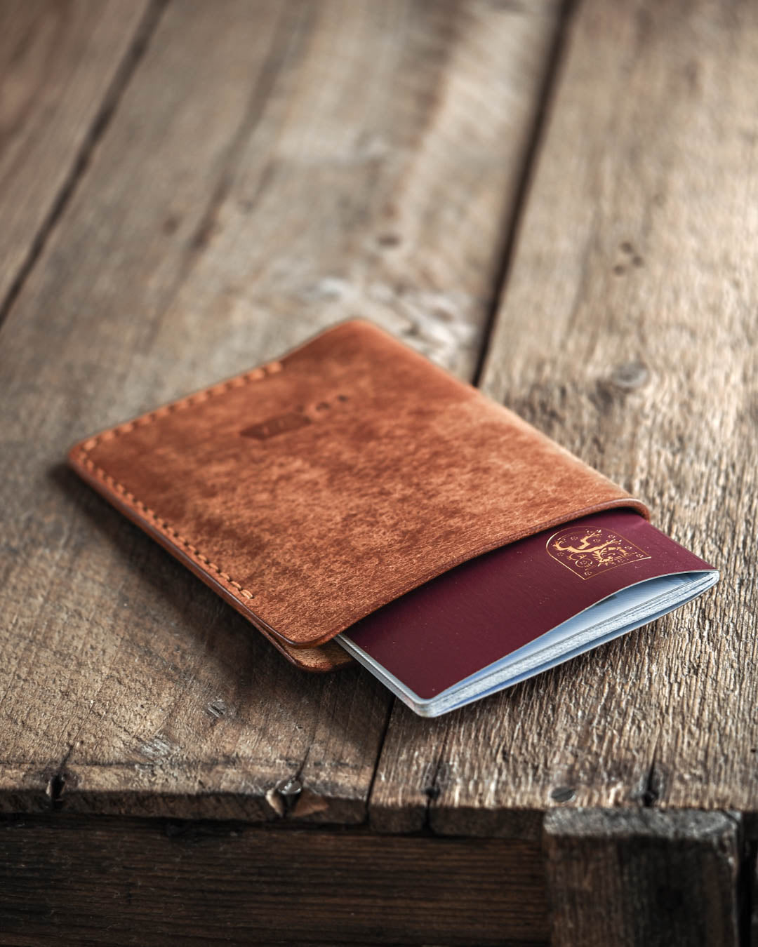 Luava handmade leather passport cover. color cognac. front in use