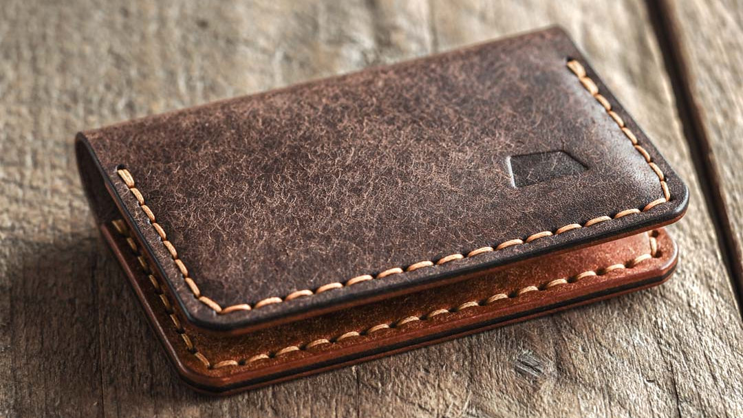 Handmade leather bi-fold wallet for men in color dark brown