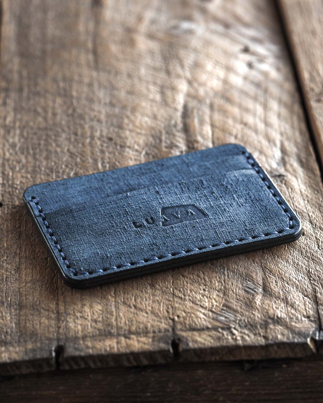 Handmade fabric like vegetable tanned full grain leather wallet made with blue leather. Proper wallet front